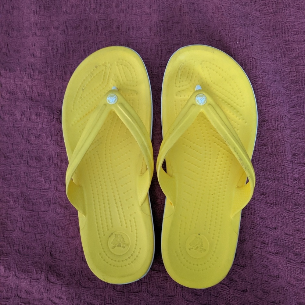 Yellow Crocs flip flops